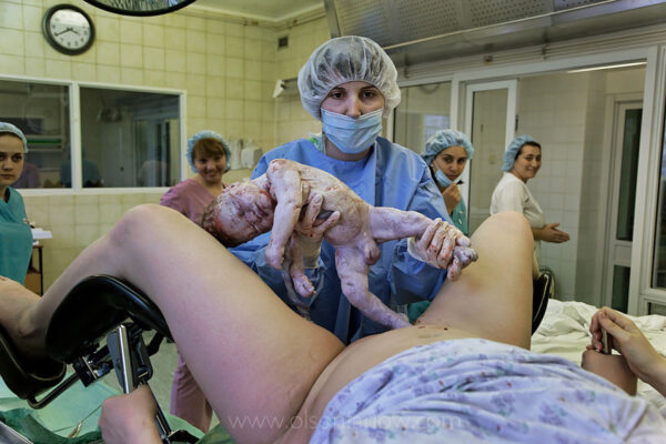 Russian Women Paid to Have 2nd Child | Moscow Maternity Ward, Russia
Alyona Kozlova, 23, gives birth at the Moscow Planning Center and Reproduction Maternity Home where about 8,000 babies, or about 20 per day, are born every year. This is the most of any maternity hospital in Russia. In 2009, 117,000 babies were delivered in all of Moscow and a total of 1,800,000 were born in Russia, which is only 27,000 more than deaths that year. Russia is basically at the replacement rate, but there are not as many parents so the state has instituted a number of incentive policies including free housing for immigrants and a one-time payment of over $10,000 for a woman to have either a second, third or fourth baby. 
The federal program called “Mother’s Capital” started in 2007 and stipulates that every mother gets this money after having a second (third, fourth, etc) baby. The law also stipulates that Mother’s Capital can be invested into:
1.Improvement of living conditions
2.Education of the child (after the child reaches the age of 3 years)
3.Invested into mother’s pension
At present the government reports that the program has started to work, though some experts disagree. The latest reports from the government’s Ministry of Health Care saw that during first quarter of 2009, 394,300 babies were born in Russia, which is 4% more compared with the same period in 2008.
