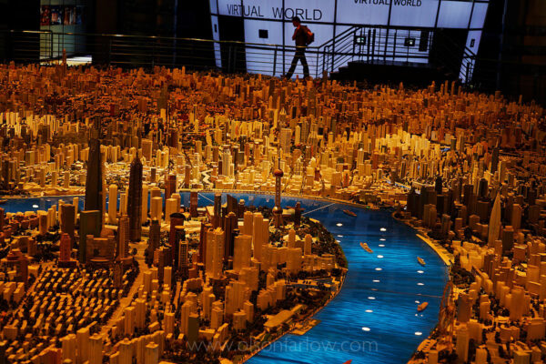 Urban Planning Museum | Urbanization in Shanghai, China
The City Planning Museum is just off People’s Square in the Puxi side of Shanghai.  Models show not only the buildings that are already done, but also those planned for the future. All goes according to plan, but not with a lot of rights for individual Chinese.
Since 2000, China’s cities have expanded at an average rate of ten percent annually. The country’s urbanization rate increased from 17.4% in 1978 to 46.8% in 2009, a scale unprecedented in human history. Between 150 and 200 million migrant workers work part-time in the major cities, returning home to the countryside periodically with their earnings.
Today, the People’s Republic of China has dozens of cities with one million or more long-term residents, including the three global cities of Beijing, Hong Kong, and Shanghai. The figures in the table below are from the 2008 census, and are only estimates of the urban populations within administrative city limits; a different ranking exists when considering the total municipal populations (which includes suburban and rural populations). The large “floating populations” of migrant workers make conducting censuses in urban areas difficult; the figures below do not include the floating population, only long-term residents.
