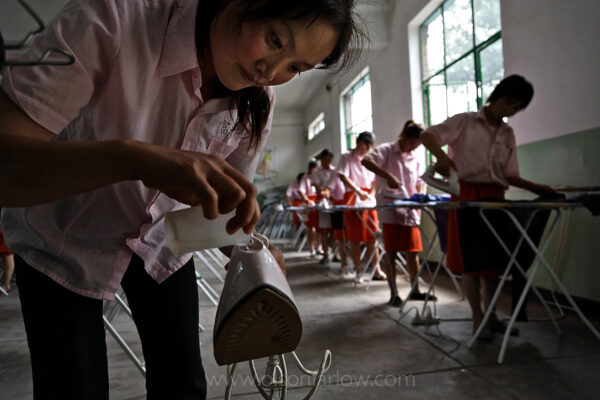 Girls from rural countryside learn skills at the Fuping Vocational Skills Training School to be maids for the newly wealthy comfort class. Since opening up its economy in 1978 and moving toward a market economy, China has lifted about 400 million people out of poverty, but this has led to wide income inequalities. The Communist Party is trying to address this through its notion of a “harmonious society” that has a more even distribution of the benefits of recent decades of speedy economic growth. Migrant workers in China are mostly people from impoverished regions who go to more urban and prosperous coastal regions in search of work. According to Chinese government statistics, the current number of migrant workers in China is estimated at 120 million (approximately 9% of the population). China is now experiencing the largest mass migration of people from the countryside to the city in history. An estimated 230 million Chinese (2010), roughly equivalent to two-thirds the population of the U.S., have left the countryside and migrated to the cities in recent years. About 13 million more join them every year—an expected 250 million by 2012, and 300 to perhaps 400 million by 2025. Many are farmers and farm workers made obsolete by modern farming practices and factory workers who have been laid off from inefficient state-run factories. Overall, the Chinese government has tacitly supported migration as means of transforming China from a rural-based economy to an urban-based one.
