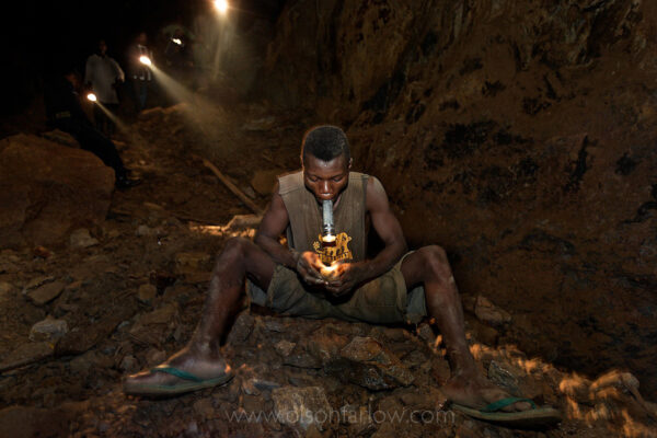 Scrapping Gold From Old Belgian Mines | DR Congo
Most Africans in the Congo work where the Belgians already explored.  Congolese try to eke little bits of gold from the old mine tunnels and cracks in the earth left by the Belgians. Belgians moved very quickly into their colony with heavy machinery to extract gold to finance the war effort during WWII. I found this guy a couple of KM down an old shaft holding a flashlight in his mouth and knocking two rocks together to try and find gold.
