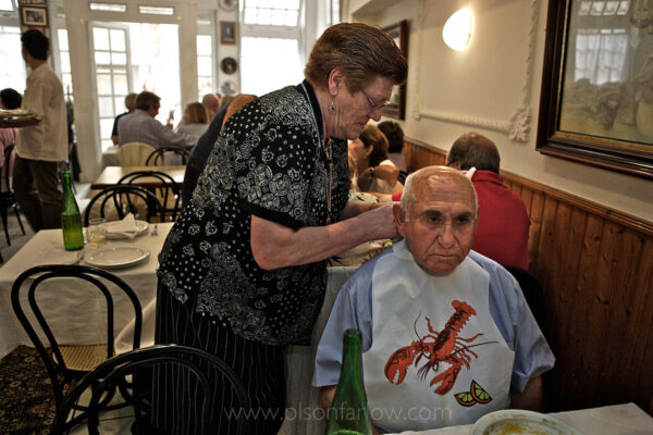 This is Olga, tying a bib on one of her customers; she has the best seafood restaurant in Galicia, Spain.  The only thing Olga likes better than boiling lobster is singing Franco tunes with her fascist buddies.
