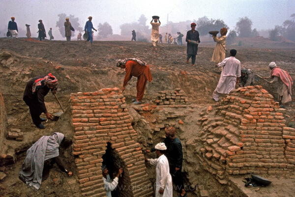 Workers excavate the main drain for the Harappa site. The drain is located at one of the main gates to the city. Indus valley communities are within a days walk of each other, had the first known sewer systems, standardized mud brick structures, systems of trade and measure, seals (credit cards), and other inventions that exist to this day.  Recently in Gujarat after an extended drought caused deaths from a shortage of water, emergency workers and heavy equipment were brought in to build a temporary reservoir.  One of the bulldozers ran into the corner of a huge reservoir, constructed during ancient times, that was by far superior to anything the locals have today.
