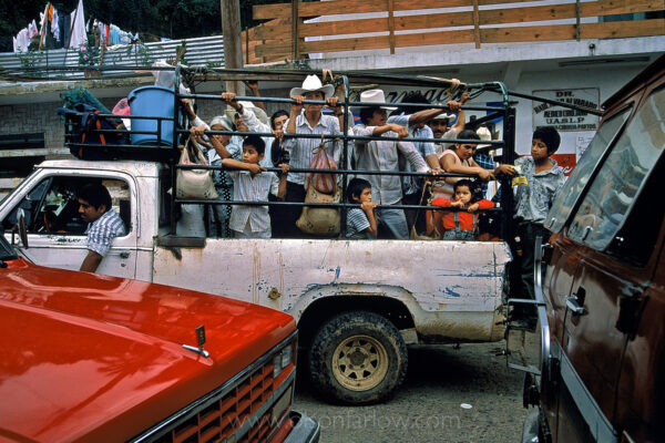 Farm families crowd in a truck on their way home from an Indian market in Mexico. Streets are chaotic on Sunday in this small Huastec mountain village when the narrow streets fill with people coming to buy and sell animals, locally grown coffee, sugarcane, copal incense and corn tamales.  South of Ciudad Valley, the Pan American highway passes through Huasteca Indian country. The population was once estimated to be one million, but today they number about 150,000.
