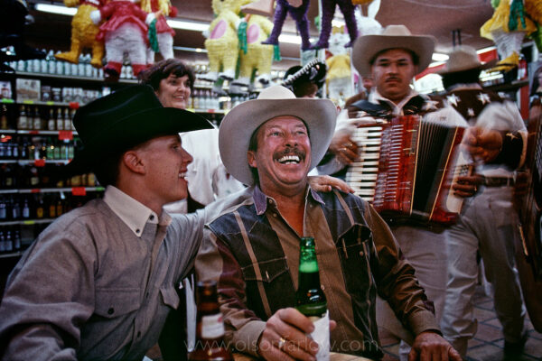 A father and son cross the Mexican border to celebrate a 21st birthday at a bar in a border town to Laredo, Texas.  The two laughed and sang with the Mariachi band in the atmosphere among other tourists among the piñatas.  Nuevo Laredo is known for its lively nightlife, but Texas authorities are discouraging resident from crossing over because of recent gang-related violence.
