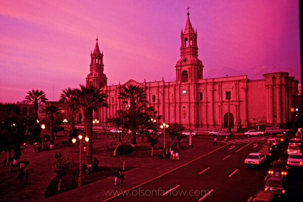 El Misti volcano rises behind the Basilica Cathedral of Arequipa on the Plaza de Armas, which radiates a shocking sunset glow in the city of Arequipa, Peru. The imposing Catholic Church is one of Peru’s most unusual and famous colonial cathedrals since the Spanish conquest. The cathedral was originally constructed in 1656 and stood for two centuries until it was gutted by fire. It was destroyed in an earthquake in 1868 and rebuilt although it has sustained damage from earthquakes many times. A large earthquake hit Arequipa in June of 2001, which toppled one of the cathedral’s towers.
