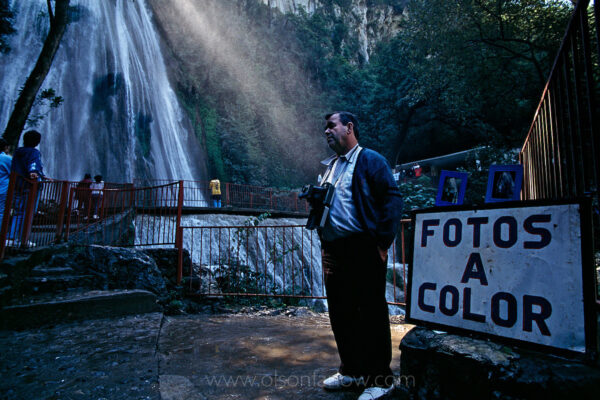 A photographer has sold Polaroid pictures to tourists at the base of Cascada Cola de Caballo, Horsetail Falls, for 50 of his 73 years. The waterfall makes a dramatic 75 foot drop through Cumbres de Monterrey in Las Cumbres National Park south of Monterrey, Mexico.  The falls and surrounding park are a draw for Mexican families for picnics.
 

