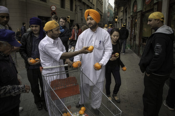 Indian Immigrants, Ramblas Catalunya | Barcelona, Spain
Indians in Spain celebrate Vaisakhi, an ancient North Indian harvest festival, which includes the passing out of huge amounts of food. A procession began on Ramblas de Catalunya, a major street in Barcelona, and continued along Ramblas Raval, and ended at the Plaza St. Augustine. 
These Sikhs from Punjab hauled shopping cart after shopping cart full of fresh fruit and handed it out to the general public. Booming Spain was Europe’s largest absorber of migrants from 2002 to 2007, with its immigrant population more than doubling as 2.5 million people arrived.
