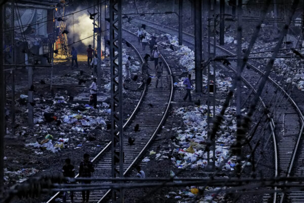 



Early morning in the Dharavi Slums of Mumbai, people walk along the train tracks that are lined with piles of trash. This area is the third largest slum in the world and one of India’s homes to plastic recycling. Garbage piles up and bags blow in, and pickers are drawn there to sort through it daily.  




