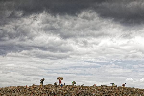 Storm clouds build over plastic workers combing the Bantar Gebang dumpsite outside Jakarta, Indonesia. It is one of the biggest landfills, and security guards report that over 100 trash pickers have died working close to tractors while they were scavenging. The only material workers look for is plastic.
