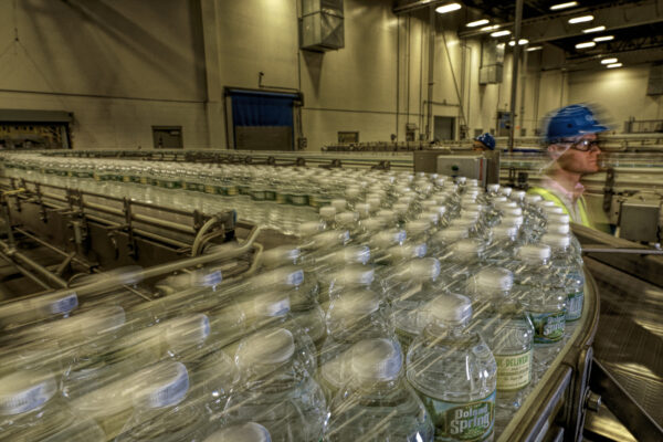 



Bottles move down the conveyer belt at Poland Spring where between 345 and 425 employees working at the Hollis, Maine site oversee an array of computers and the water bottle production line. The 838,000 square-foot facility is the largest bottled water plant in the world, turning out about 80 million cases of water every year. Some of the machines fill 1,200 bottles per minute.




