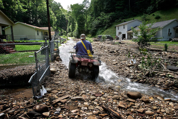 A four-wheeler drives up a rock-covered road that was flooded after a summer thunderstorm.
Communities near mountaintop removal mining sites are often subject to powerful flash floods. On treeless, steep mountain and valley fill slopes, rainfall quickly becomes dangerous.
Reports in the Charleston Gazette show in May 2009, Mingo County and the surrounding coalfields were hit with the 19th floods in 11 years. WV has always flooded, but with the loss of sediment after forests are cut and the diversion of waters, flooding is happening where it never has before.
