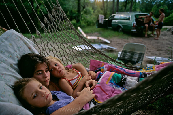 Children lie in a hammock during a family camping trip along the St. Marys River, a quiet meandering river popular with local families on a 4th of July weekend. White sand beaches line the black water river as it makes it 126-mile long trek from the Okefenokee Swamp to the Atlantic Ocean, forming the border between Florida and Georgia.
