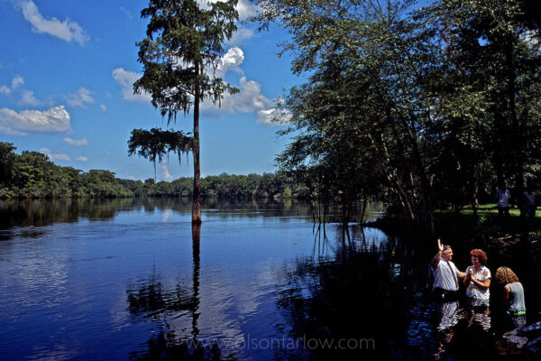 Sunday morning baptism in the Suwannee River is a tradition near Bell, Florida. Outdoor baptisms were common in the South in the 1950s, but many Christian churches have indoor facilities today, so few believers gather at the water for submersion in a river to proclaim their belief in Christ.
