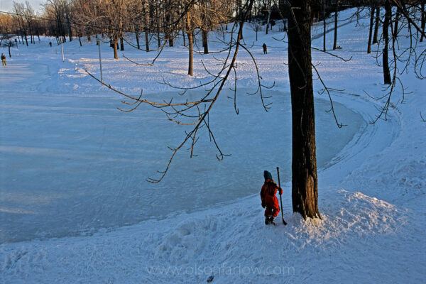 A lone hockey player circles the edge of Beaver Lake in Canada’s Mt Royal Park (in French: Parc du Mont-Royal), where winter visitors can cross country ski and snowshoe.
Frederick Law Olmsted designed the park to emphasize the areas mountainous topography. The city fell into hard times and never implemented all of his plans, but it is still the greatest of Montreal’s greenspaces.
