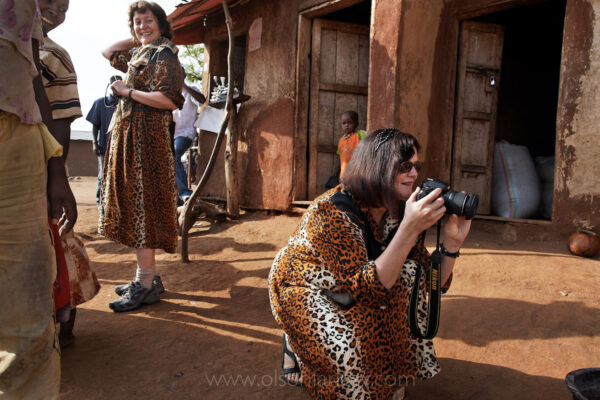 Austrian tourists in matching, fake cheetah-print dresses shoot snapshots for souvenirs of local women with lip plates near the town of Jinka. With its rich culture still intact, the Omo region has seen tourism boom—and tensions between visitors and residents rise.  “They know that tourists want to come see them because they are viewed as savages,” says one anthropologist. “They are angry with this.”
