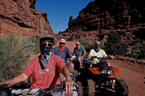 Bandit-style bandannas shield law abiders from dust on a well-worn trail in the Fisher Towers region of the Castle Valley near Moab, Utah.
Off-road vehicle riders who stick to the Bureau of Land Management’s loosely enforced straight-and-narrow rules are plentiful, but thousands more disregard the rules, answering the call of their combustion engines to chart new paths through roadless areas. The resulting degradation has growing environmental consequences—the vehicles crisscross delicate ecosystems, cutting through the dry soil and disturbing fragile plants—in areas that take years to recover from disturbances.
