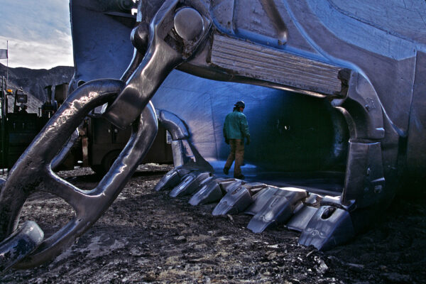 A worker stands inside an idle bucket that can hold 170 cubic yards of material while unearthing rock in a coal seam. Arch Coal employs over 500 workers at the Black Thunder Mine, which for many years was the nation’s single largest coalmine in Wyoming’s Powder River Basin.
Five draglines work the 70-foot Wyodak seam, producing more than 65 million tons of coal annually on federal land. Once the low-sulfur, sub-bituminous coal is crushed it is suitable for power station fuel without any other preparation.
The Black Thunder Mine produces more than two tons of coal per second, 24 hours a day, 365 days a year. According to the company web site, the mine surpassed a 750 million ton shipment milestone 25 years after opening in 1977.

