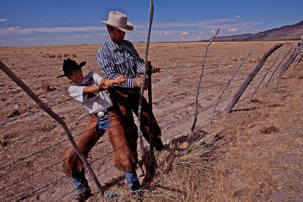Lending his weight, a young boy helps his father mend fences on Roaring Springs Ranch in Harney County, not far from Steens Mountain in Frenchglen, Oregon.
Ranchers and environmentalists mended fences of their own to reach a mixed-use plan for the area. Preservation of the mountain was a priority for both sides, but each held different opinions on the best way that could be achieved. Meetings were held at the Roaring Springs Ranch in 2000 and a compromise was reached, balancing ecological factors and ranching traditions.
