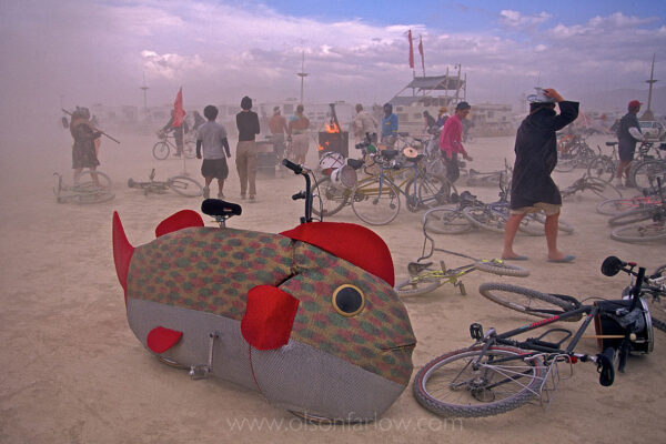 A fish bike is abandoned in the Great Basin lakebed that is a dry remnant of the Pleistocene-era Lake Lahontan.
People take cover from the harsh sandstorm winds at the annual, weeklong Burning Man Festival. The counter-culture event celebrates art on public land in the Black Rock Playa, which is a dry lakebed in northwestern Nevada’s Conservation Area.
The arid desert extends 100 miles and encompasses 1,000 square miles of wilderness.
