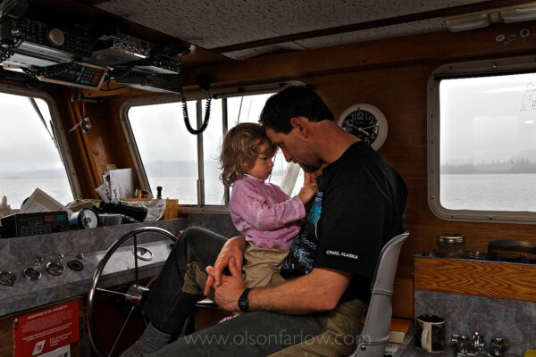 Father and daugher share a moment on their boat which is home for the family during fishing season off the coast of Prince of Wales Island in Alaska’s Southeast. When not the fishing for salmon, the family lives on nearby Marble Island and the children are home schooled.
Alaska’s largest and most valuable fisheries target salmon, pollock, crab, herring, halibut, shrimp, sablefish, and Pacific cod. The total value of Alaska’s commercial fisheries is $1.5 billion for the fishermen, with a wholesale value of $3.6 billion. Economists estimate the commercial seafood industry contributes $5.8 billion and 78,500 jobs to the Alaskan economy. Fisheries management in Alaska is based on scientific assessments and monitoring of harvested populations and is regarded as a model of successful natural resource stewardship.
