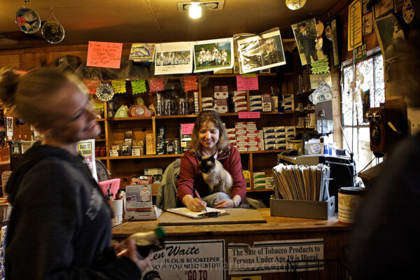 Friends come together at a general store that is one of a few businesses in Coffman Cove, Alaska, population 200. The community on Prince of Wales Island was settled as a logging town and people stayed although the industry declined. The community offers services for visitors that include a fuel station, liquor store, lodging, guiding for hunters and fishermen, a library with Internet service. and outdoor tours.

